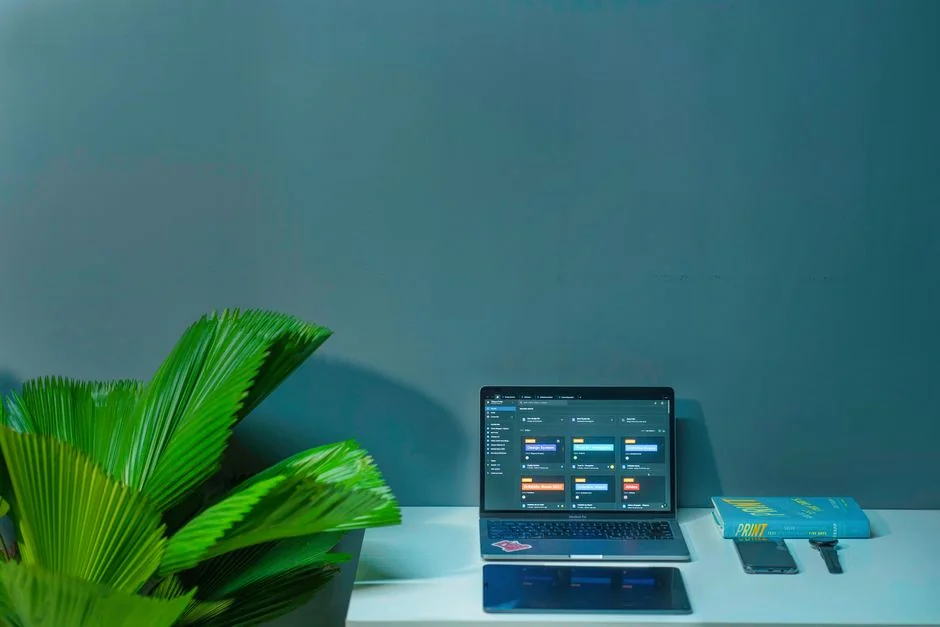 A sleek office desk setup featuring Apple devices: iMac, MacBook, and iPad.